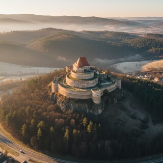 Aerial-view-of-Rupea-Fortress-on-a-basalt-hill-at-sunset-Transylvania-Romania