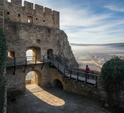 The-inner-courtyard-of-Rupea-Fortress-with-stone-arches-wooden-walkways-and-a-view-overlooking-the-Transylvanian-valley.jpg